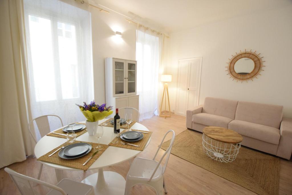 a white table and chairs in a living room at Nice Renting - BARILLERIE - COZY LOFT OLD NICE - SEA FRONT - SALEYA - MASSENA in Nice