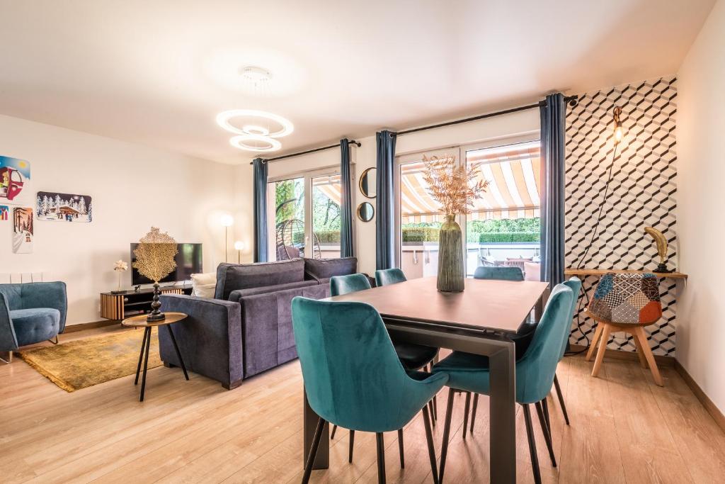 ein Wohnzimmer mit einem Tisch, Stühlen und einem Sofa in der Unterkunft La terrasse du Thiou in Annecy