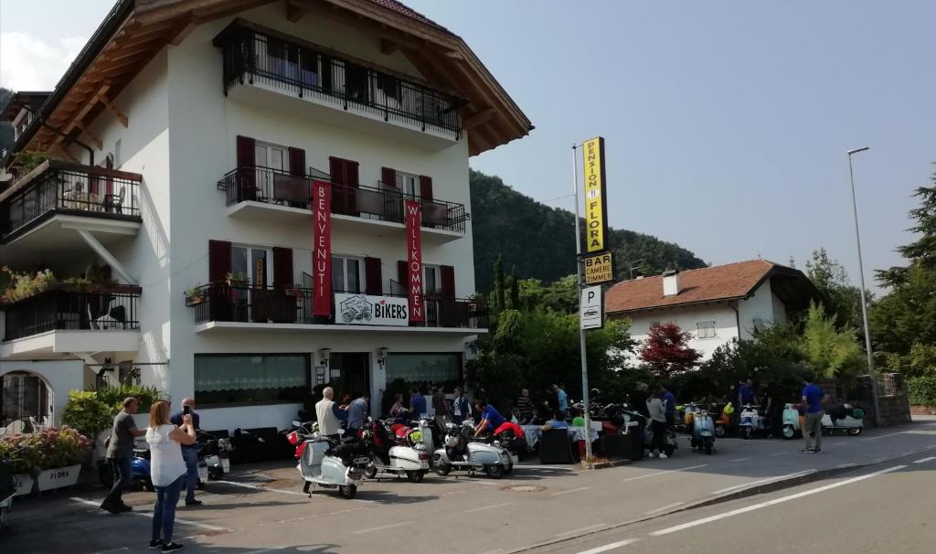 a group of people standing outside of a building at Pension Flora in Ora/Auer