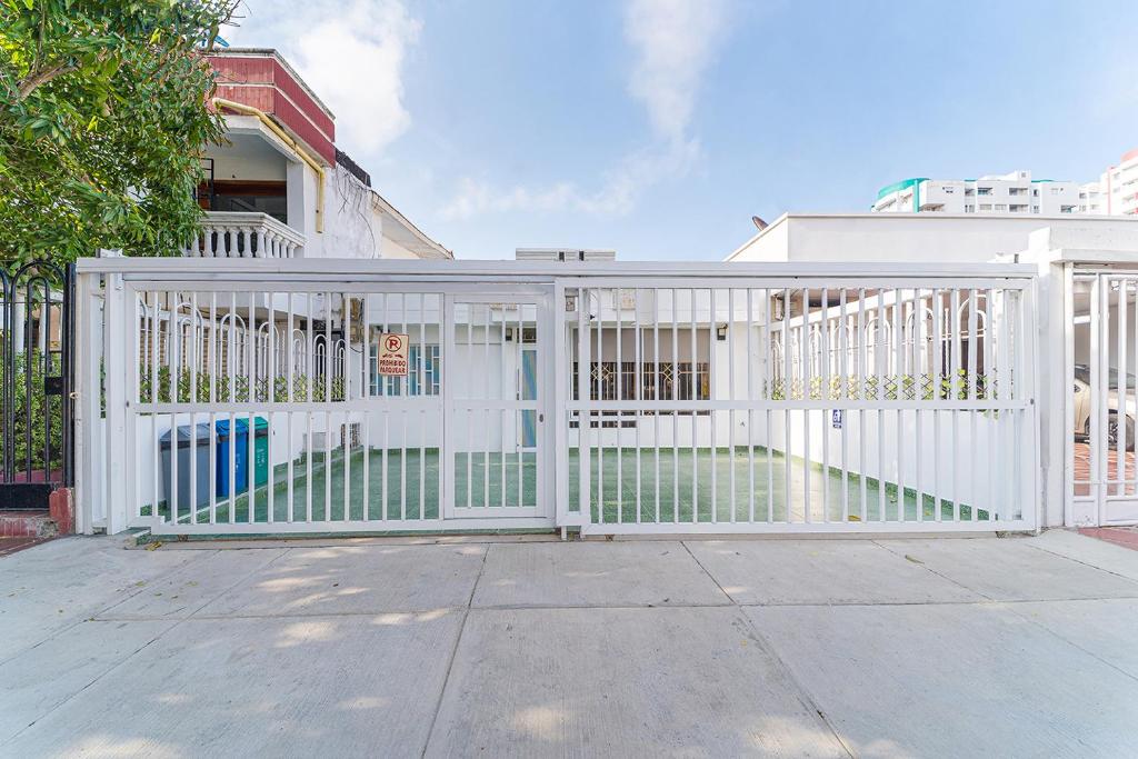 a white gate in front of a house at Hotel Casa Paraiso in Barranquilla