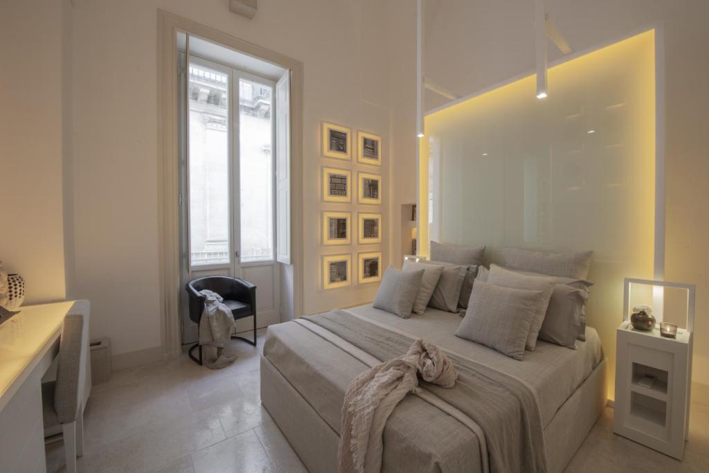 A bed or beds in a room at Palazzo Lecce - Epoca Collection