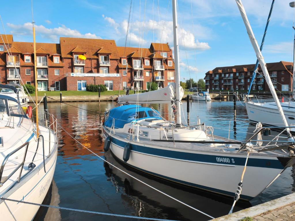 two boats docked in a marina in front of condos at Apartment Lagunenstadt Ueckermünde-3 by Interhome in Ueckermünde