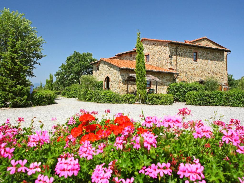a garden with flowers in front of a building at Apartment Il Pettirosso n-7 by Interhome in Starda