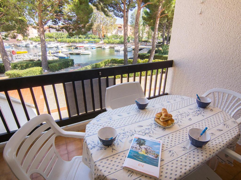 - une table blanche avec un livre sur un balcon dans l'établissement Apartment Port d'Attache-8 by Interhome, à Saint Cyprien Plage