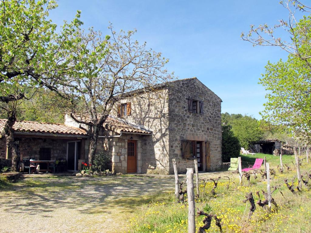 an old stone house with a table in front of it at Holiday Home Malbosc by Interhome in Saint-Genest-de-Bauzon