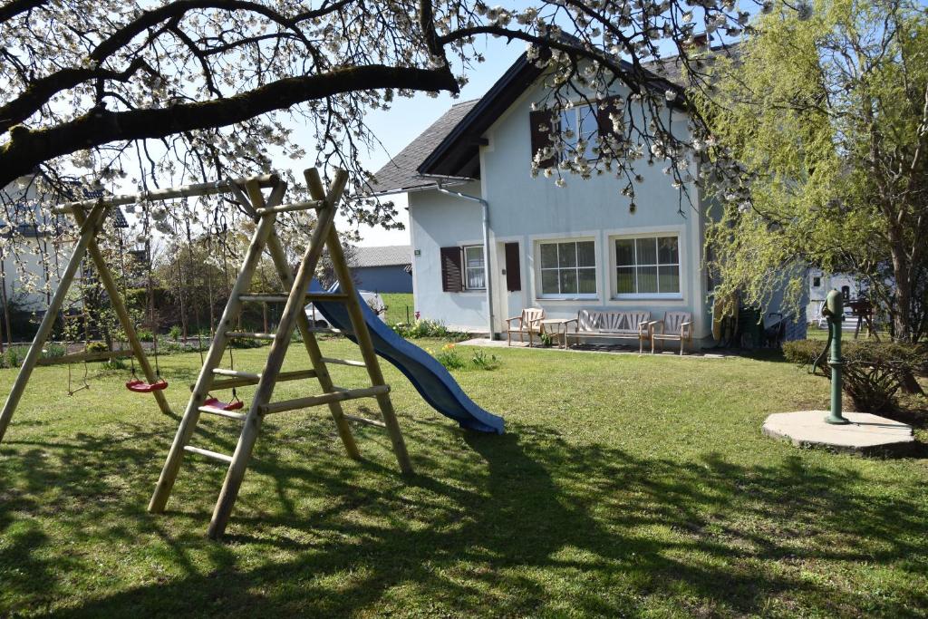 a swing set in a yard with a house at Appartement Wagner in Weiz