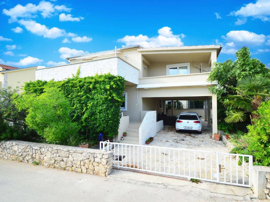 a white car parked in front of a house at Apartment Lastavica-2 by Interhome in Jadrija