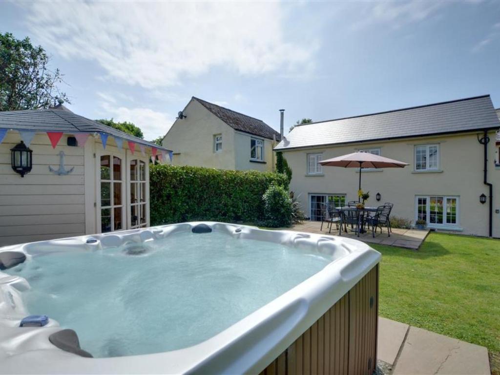 a hot tub in the backyard of a house at Holiday Home Watery Lane by Interhome in Croyde