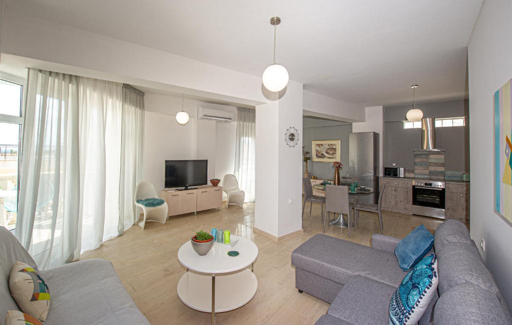 a living room with a couch and a table at Cozy Corner Analipsi Apartment in Zakynthos Town