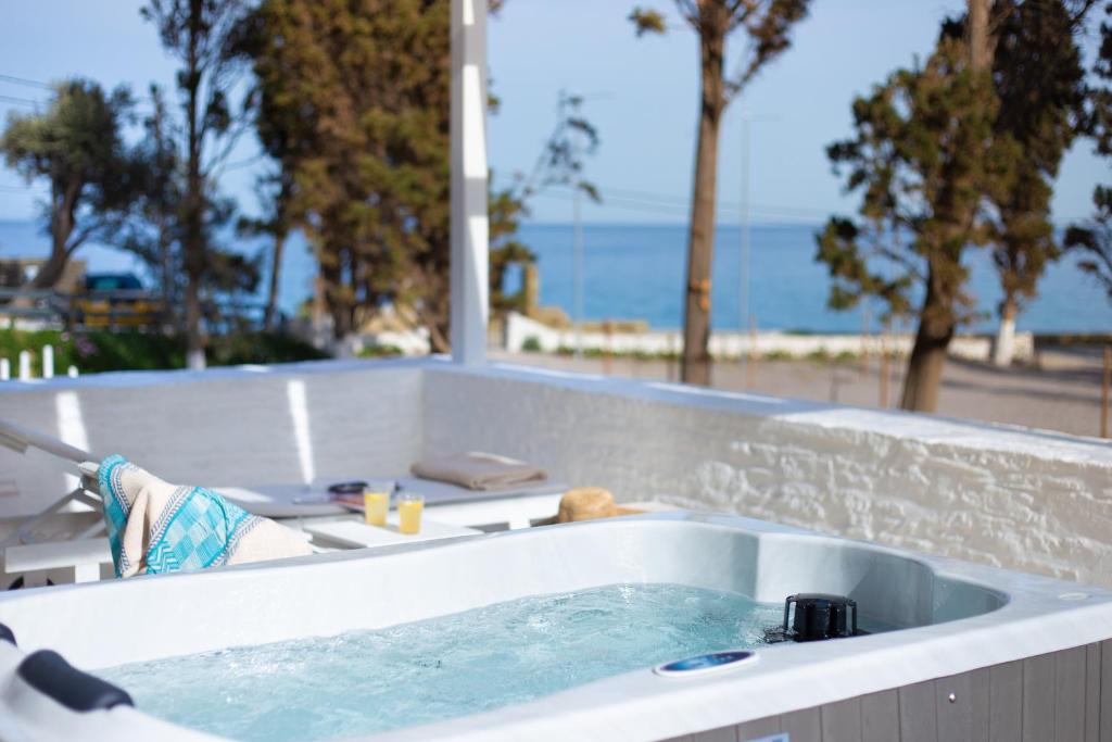 a jacuzzi tub with a view of the beach at Votsalo Seaside in Steniaí