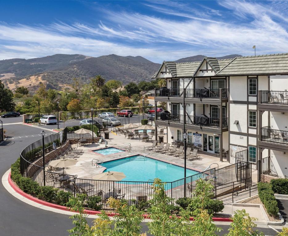 an apartment complex with a swimming pool in front of a building at WorldMark Solvang in Solvang