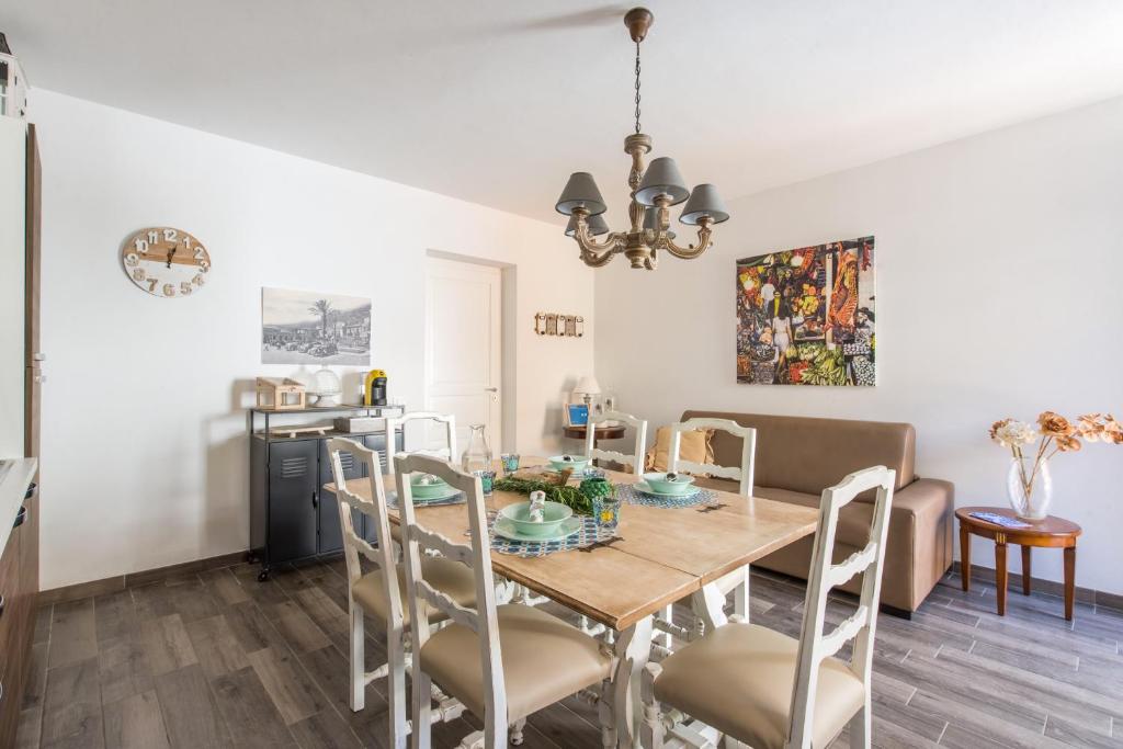 a dining room and living room with a table and chairs at Villa Cinzia-150 mt from the beach in Mondello