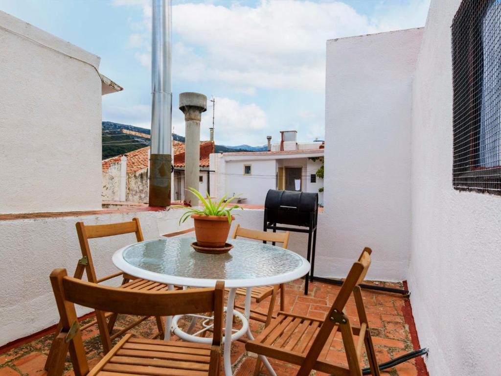 a patio with a table and chairs on a balcony at Holiday Home Hostalas by Interhome in Rosell