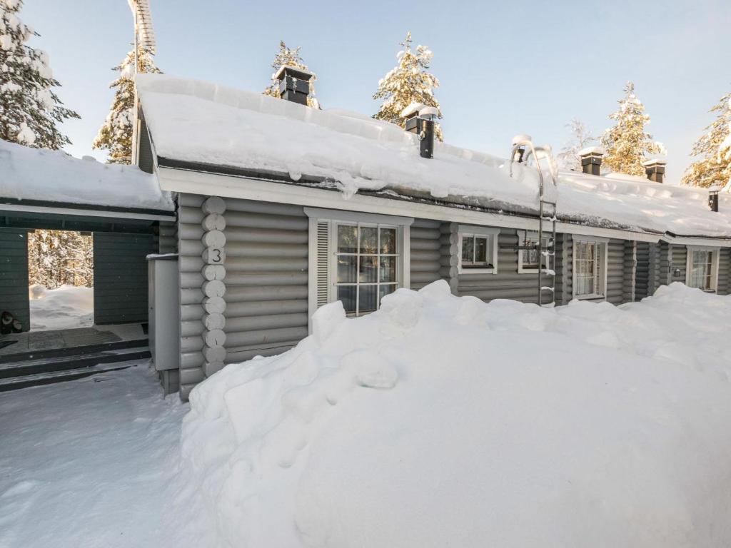 a pile of snow in front of a house at Holiday Home Ukkohovi 3 paritalo by Interhome in Hyrynsalmi