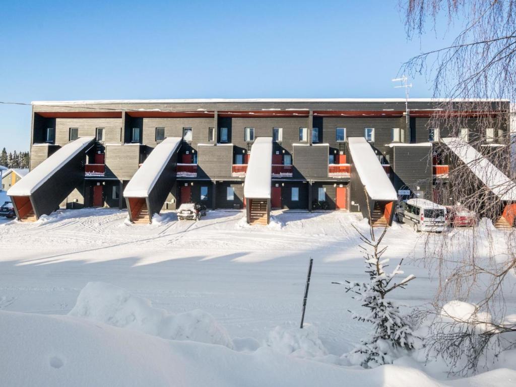 a building with a lot of snow in front of it at Holiday Home Skivillas 61 ukkohalla - b4 by Interhome in Hyrynsalmi