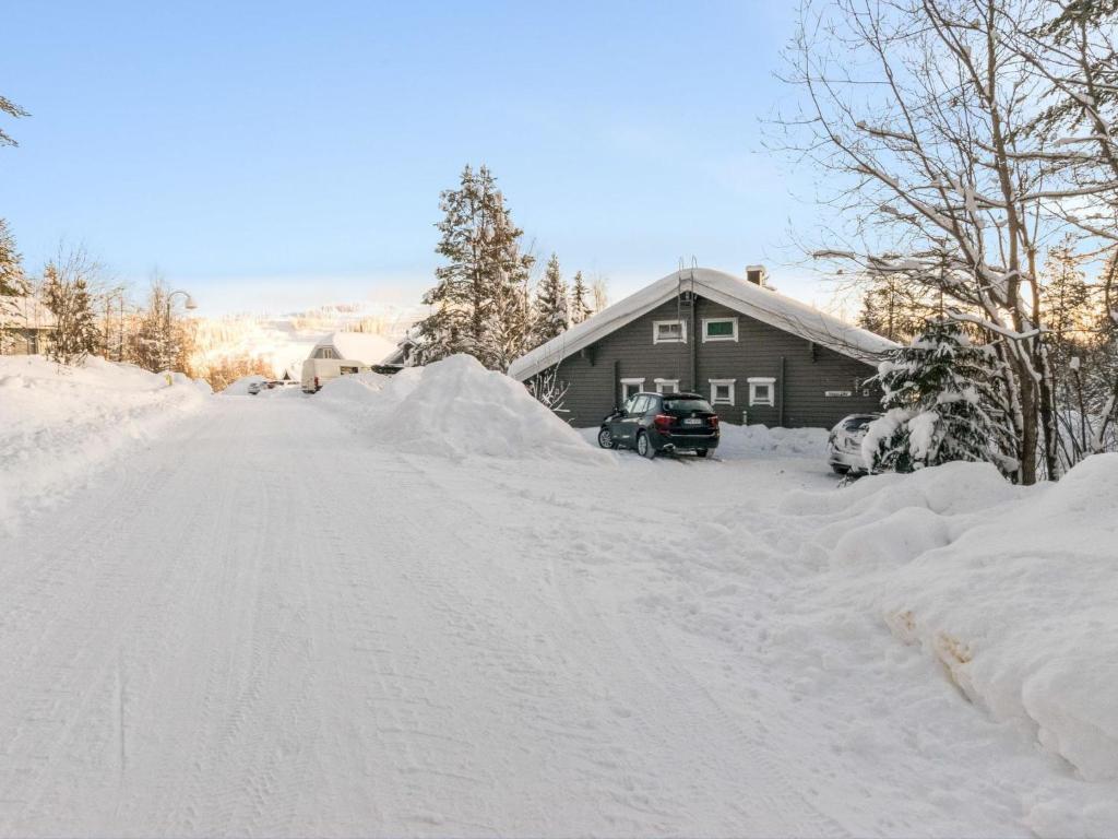 a driveway covered in snow next to a house at Holiday Home Ukkoloma b paritalo by Interhome in Hyrynsalmi