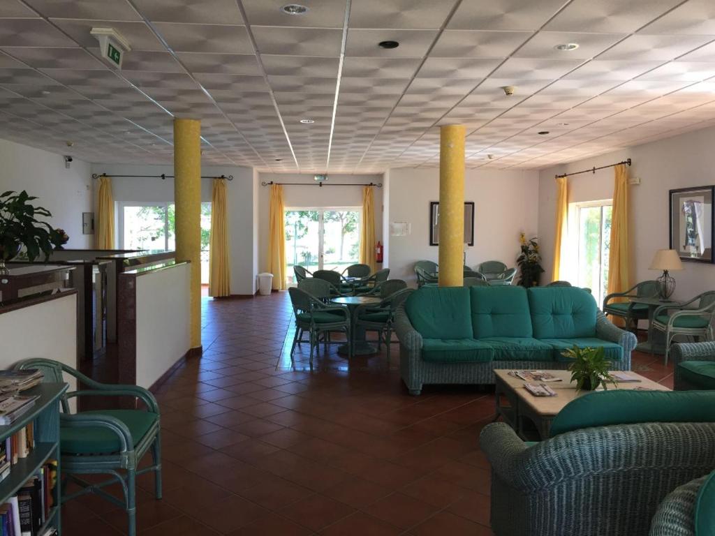 アルトゥーラにあるPrestige for Home - Apt Alagoa Praia Alturaのリビングルーム(緑のソファ、テーブル、椅子付)