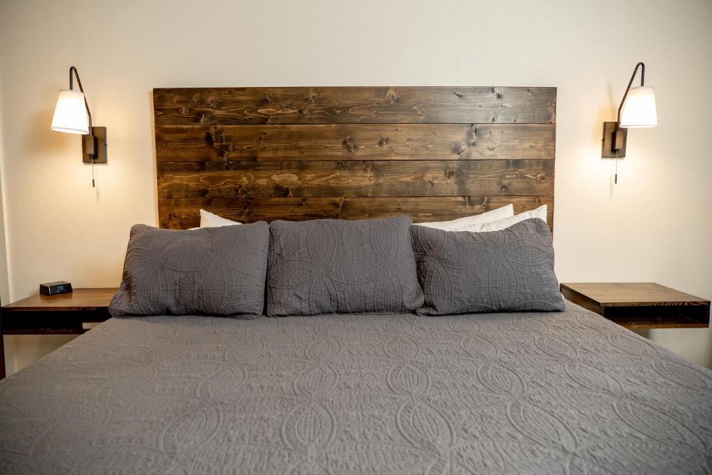 a bedroom with a bed with a wooden headboard at Eagle Cap Chalets in Joseph