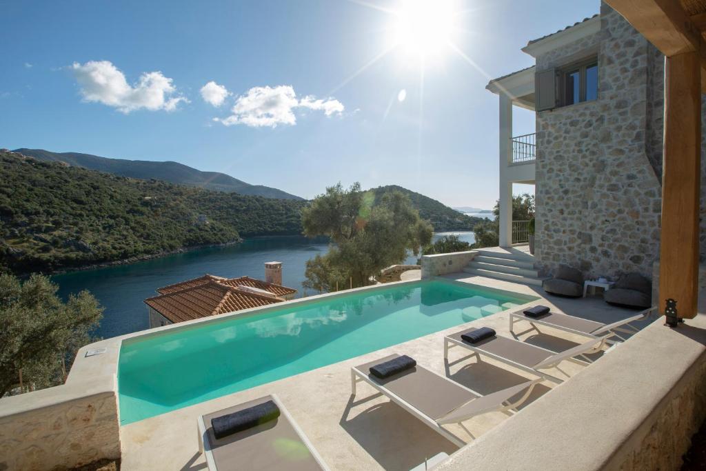 a villa with a swimming pool with a view at Villa Elanthy-New Luxury villa with private sea access in Sivota