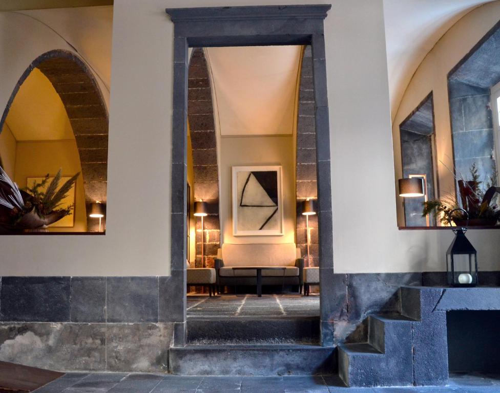 a hallway of a building with two mirrors at Hotel Do Colegio in Ponta Delgada