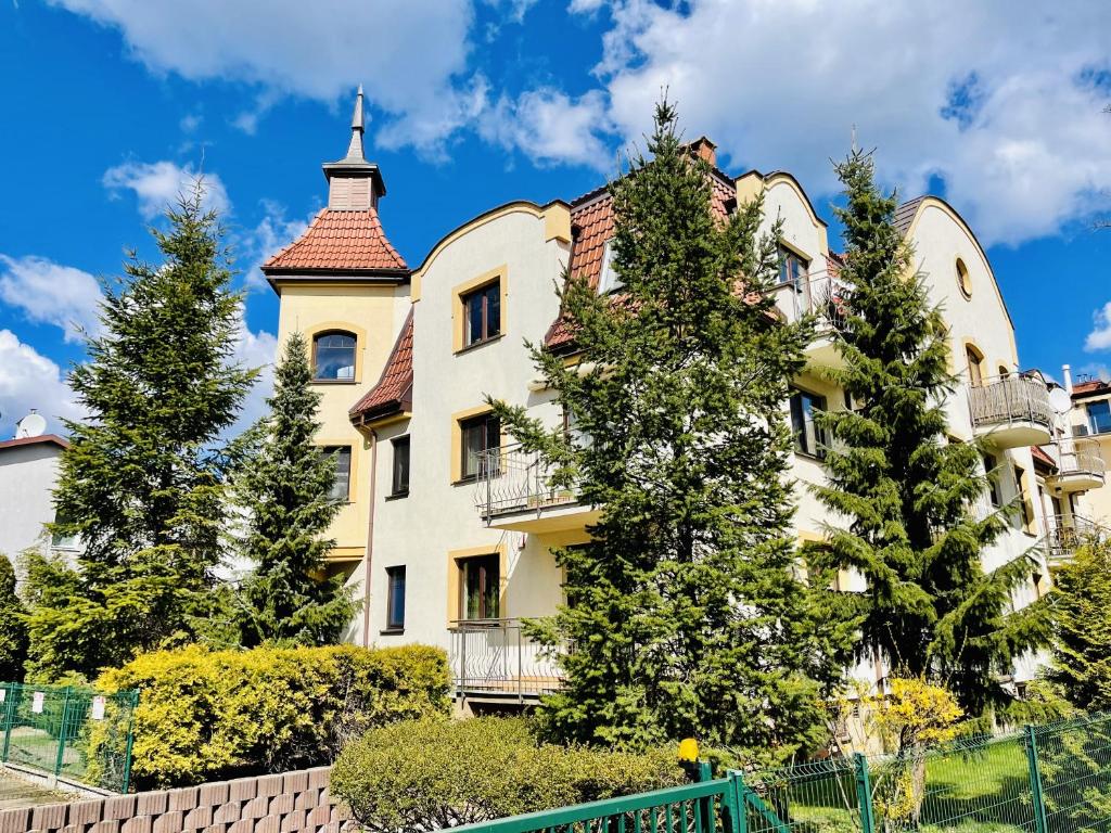 a large white building with a turret at Basha Apartment PREMIUM Sopot 2 in Sopot