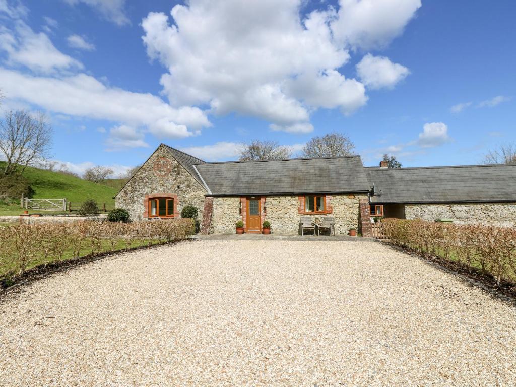 a large stone house with a gravel driveway at The Old Dairy in Newport