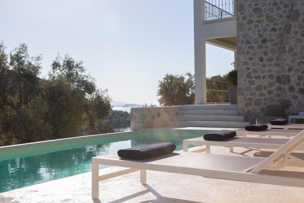 The swimming pool at or close to Villa Elanthy-New Luxury villa with private sea access