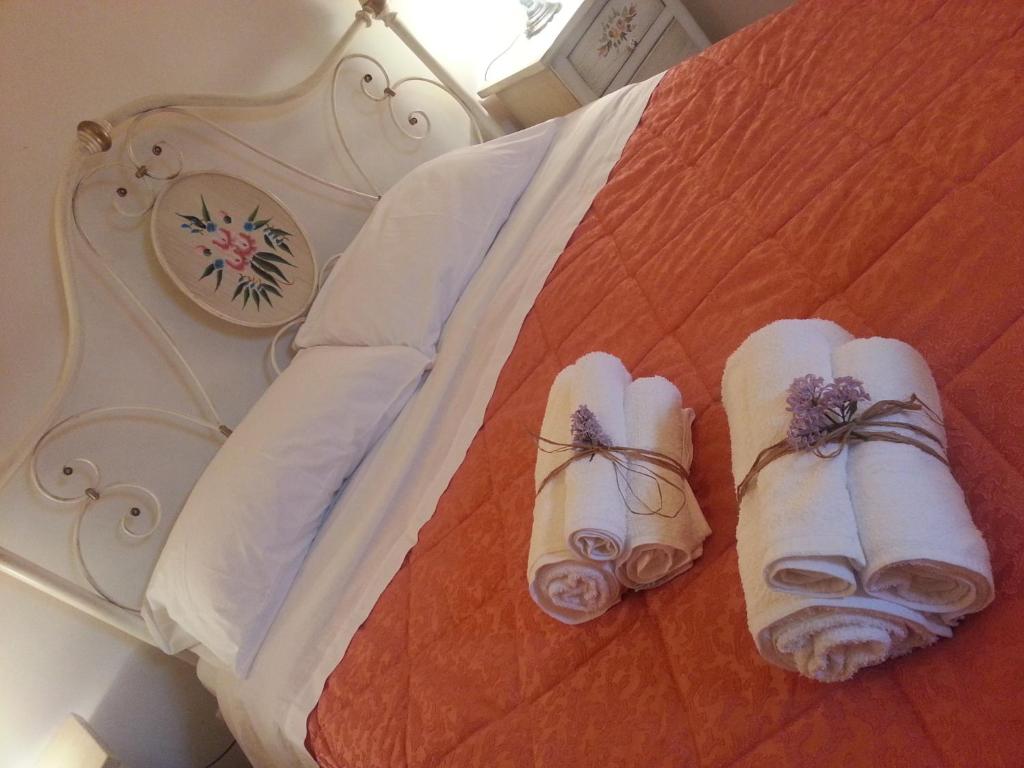 a bed with two rolled up towels on it at Barnaba Edera in Martina Franca