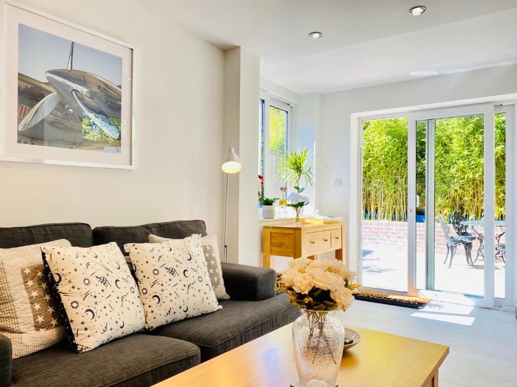 a living room with a couch and a table at Amber Lodge Hickstead-B in Haywards Heath