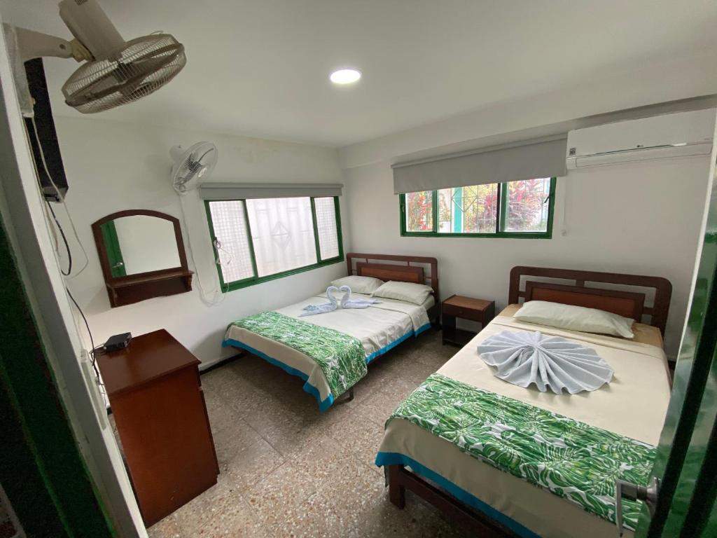 Postel nebo postele na pokoji v ubytování Hotel Maratea Melgar