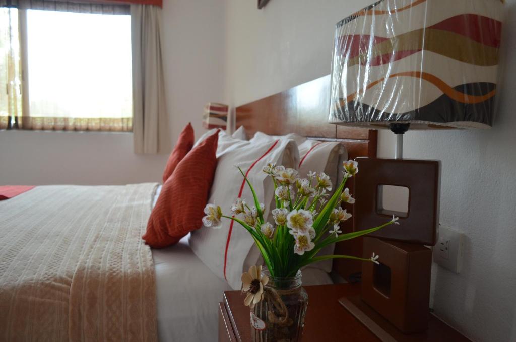 Postel nebo postele na pokoji v ubytování Hotel Real Mercedes