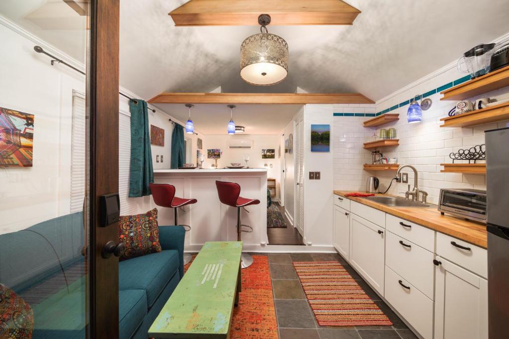 a kitchen with a couch and a table in a room at Secluded Patio Cottage Right By All The Action in Portland