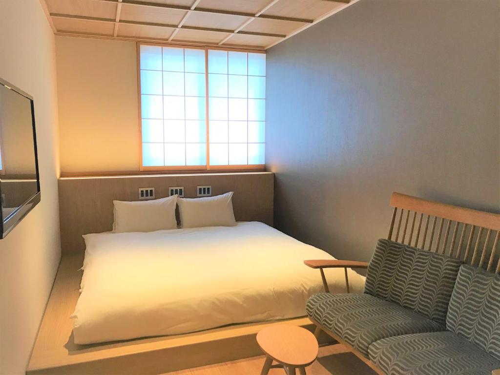 Postel nebo postele na pokoji v ubytování 利々 京都 lili hotel kyoto