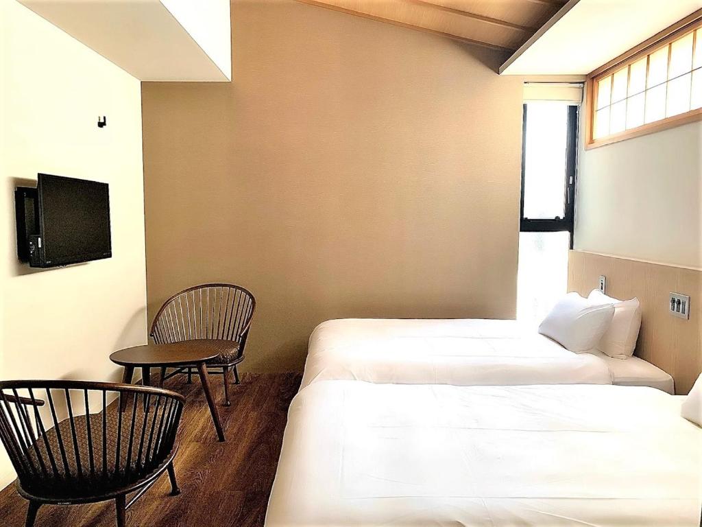 Postel nebo postele na pokoji v ubytování 利々 京都 lili hotel kyoto