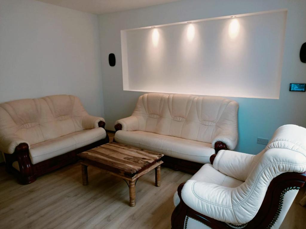 a living room with two couches and a coffee table at The Old Surgery in Blaenau-Ffestiniog