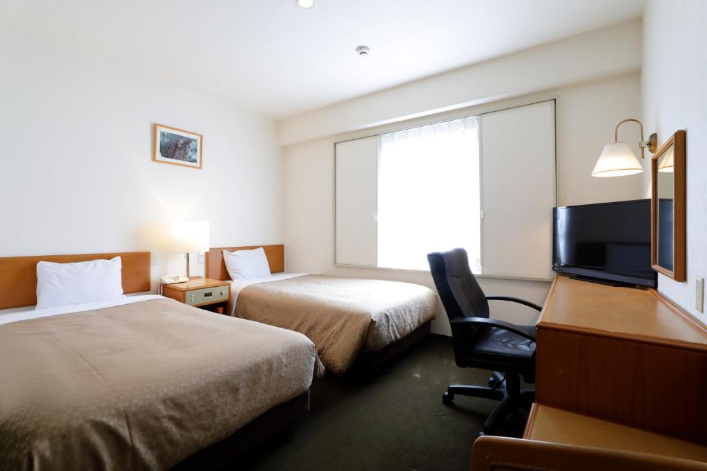 Postel nebo postele na pokoji v ubytování Kawasaki Central Hotel