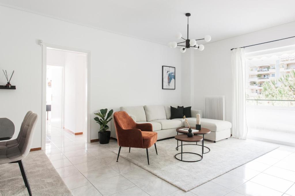 una sala de estar blanca con un sofá blanco y sillas en Splendid 3BR Apartment close to Olympic Stadium, en Atenas