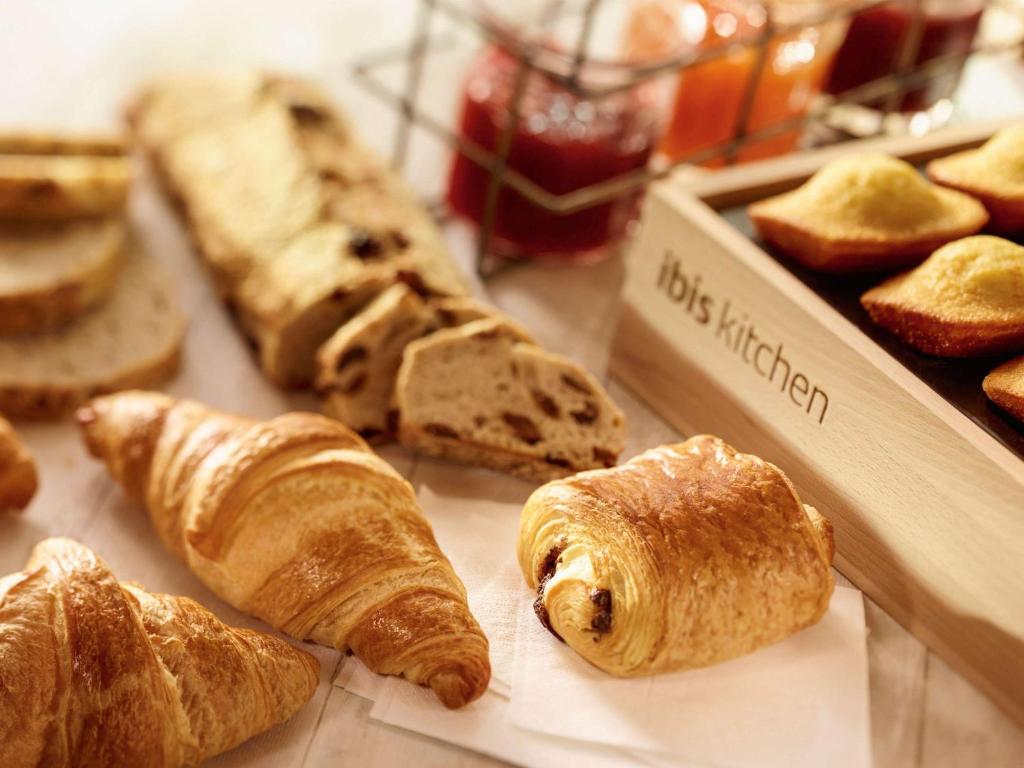 a bunch of bread and pastries on a table at ibis London Elstree Borehamwood in Borehamwood
