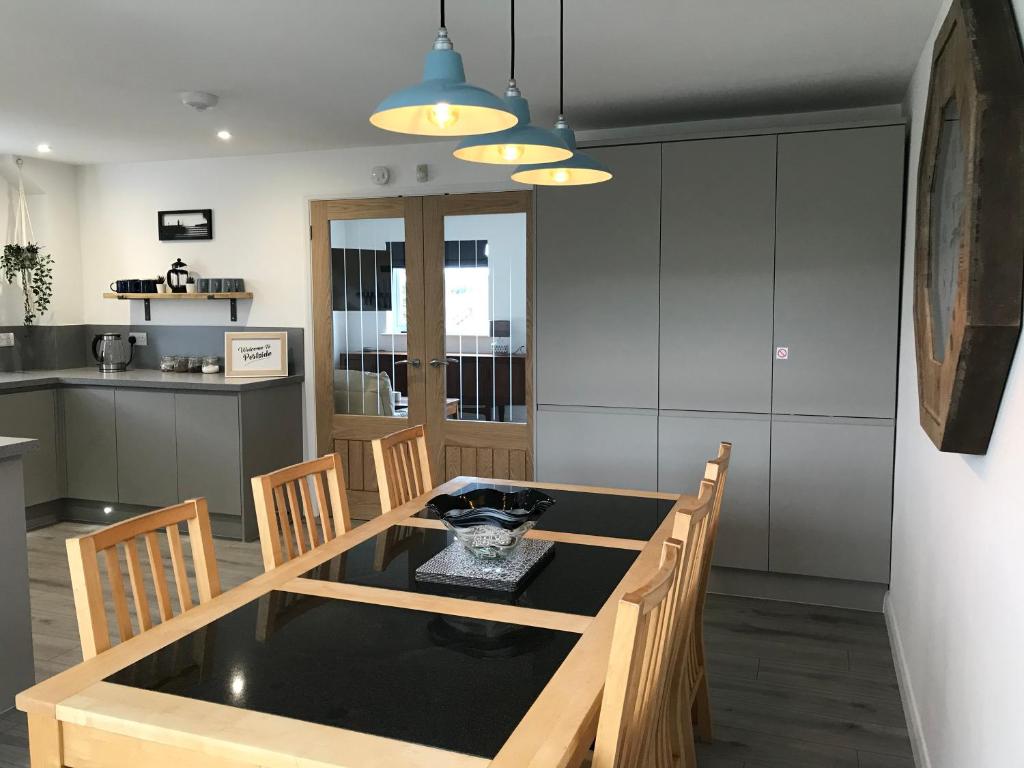 a kitchen and dining room with a table and chairs at Portside At Number 1 in St Ives
