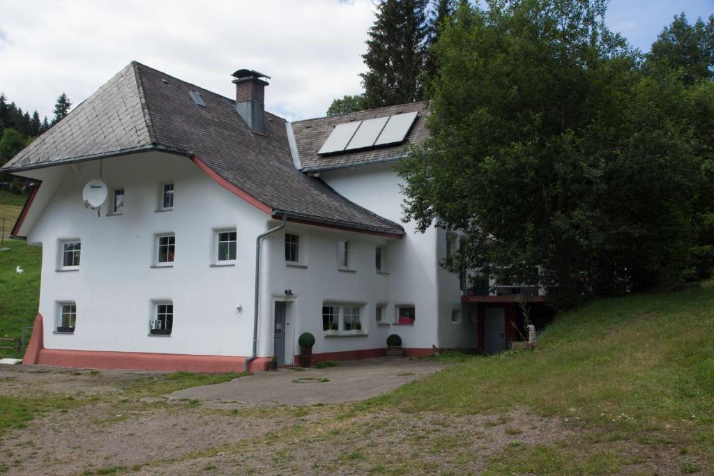 a white house with solar panels on the roof at Zur alten Oele - Hochwertig und Familienfreundlich in Lenzkirch