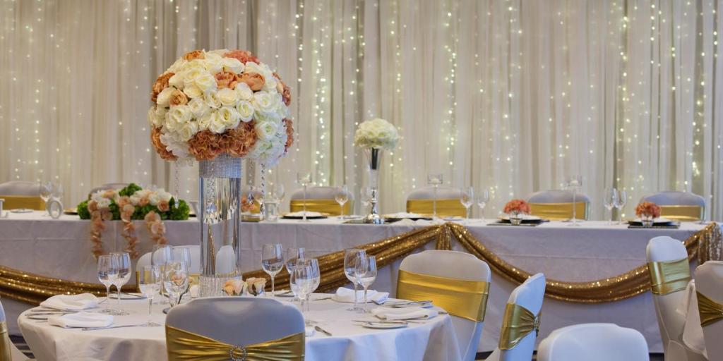 a table set up for a wedding with flowers at Crowne Plaza Aberdeen Airport by IHG in Dyce