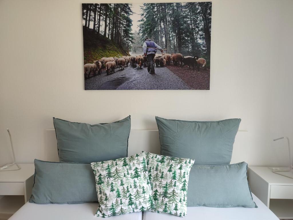 a person riding a bike with a herd of sheep at Steepleview House in Bad Peterstal-Griesbach