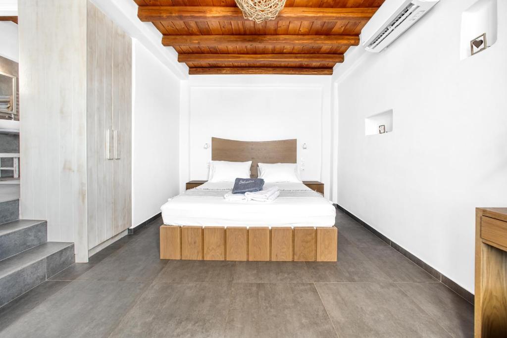 a bedroom with a bed and a wooden ceiling at Belvedere in Livadi
