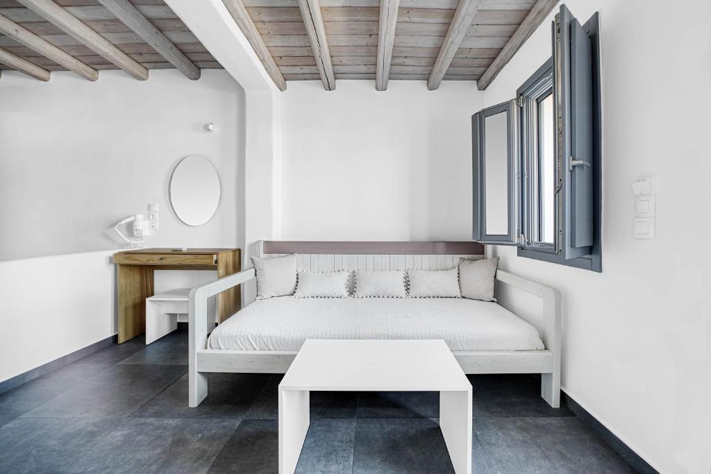 a white couch in a room with a table at Belvedere in Livadi