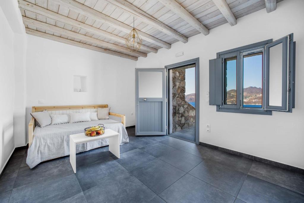 a bedroom with a bed and a table at Belvedere in Livadi