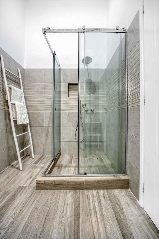 a shower with a glass door in a bathroom at Belvedere in Livadi