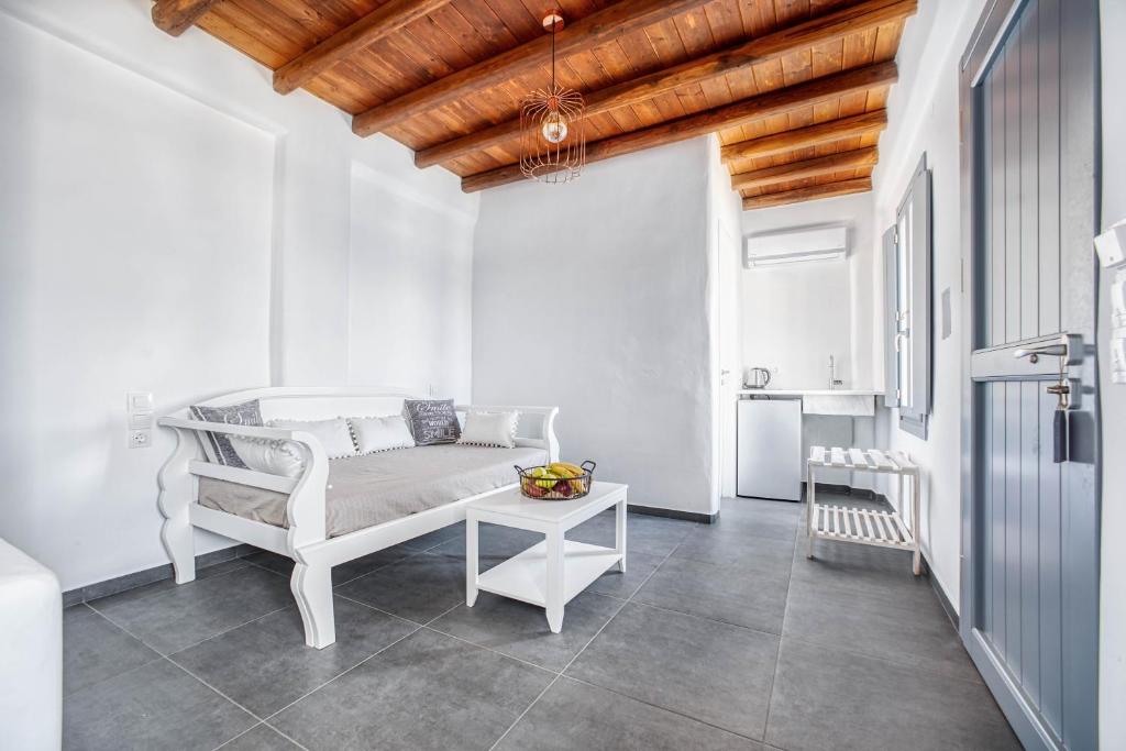 a living room with a couch and a table at Belvedere in Livadi