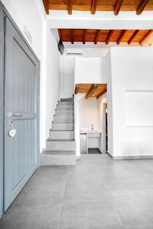 an empty hallway with a door and stairs at Belvedere in Livadi