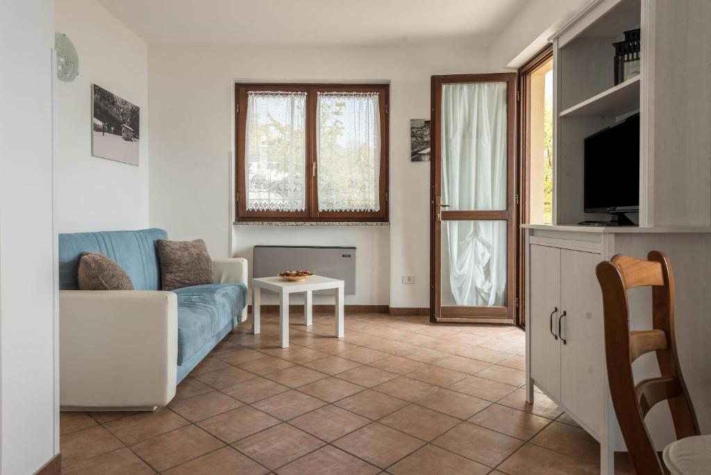 a living room with a couch and a table at Bel Soggiorno lake view 2 in Tremosine Sul Garda