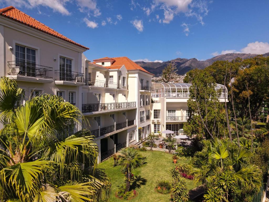 an aerial view of a building with palm trees at Quintinha Sao Joao Hotel & Spa in Funchal